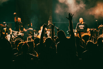 Crowd at concert and blurred stage lights.