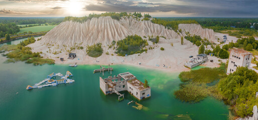 Abandoned quarry for extraction of limestone. Beautiful nature, attraction in Estonia. The summer season. Aerial rummu quarry lake with underwater prison in the middle - obrazy, fototapety, plakaty