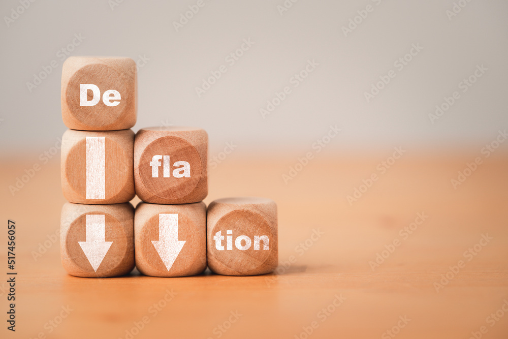 Poster deflation wording print screen on wooden cube block with white down arrow for decreasing of deflatio