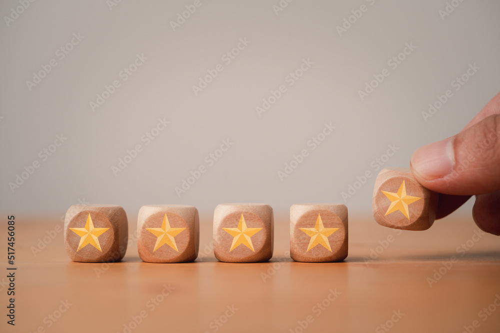 Poster Businessman Putting five stars which print screen on wooden cube block to excellent evaluate and customer satisfaction after use product and service concept.