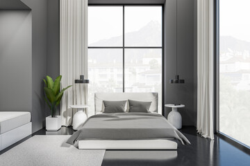 Grey bedroom interior with bed and nightstand near panoramic window