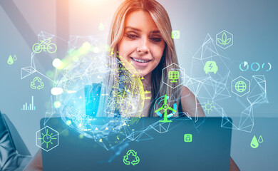 Businesswoman with laptop, earth hologram with technology and resources hud