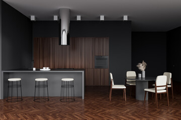 Kitchen interior with countertop and dining table with chairs on wooden floor