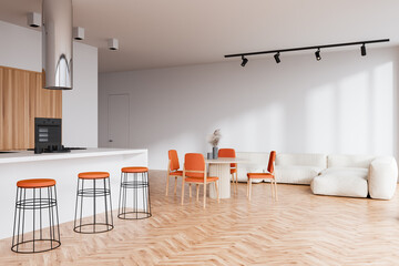 Kitchen interior with countertop, dining table and couch on wooden floor