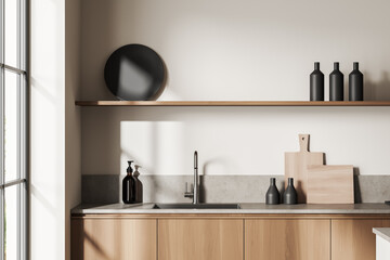 Light kitchen set interior with sink and deck with kitchenware, window