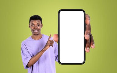 African smiling man finger point at phone with big mockup display