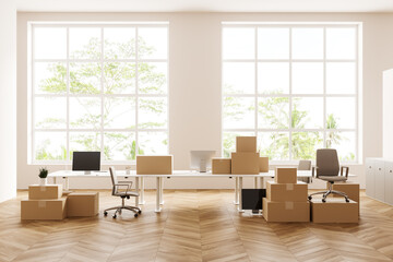 Office interior with armchair and pc computer, moving boxes, panoramic window