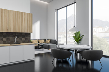 Studio interior with cooking area and relax space, kitchen shelves, panoramic window