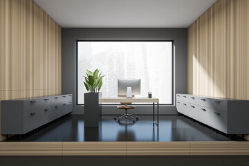 Grey office interior with desk and armchair, drawer and panoramic window