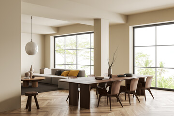 Light living room interior with dining table and couch, panoramic window