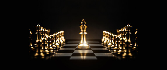 King chess piece stand on chessboard concepts of competition challenge of leader business team or...