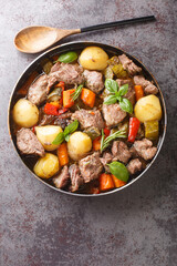 Peka Croatian Meat and Vegetable Stew close-up on the table. Vertical top view from above