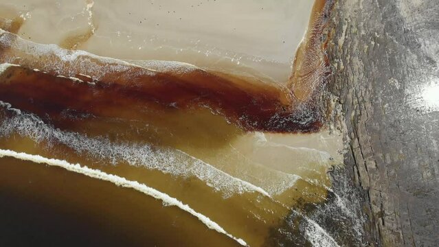 Drone video of Moona Moona Creek and Huskisson beach area after recent flooding with brown dirty water flowing into the bay