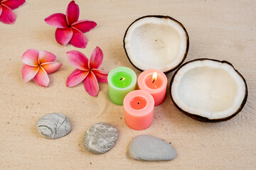 Obraz na płótnie Canvas coconut and aroma candles on beach