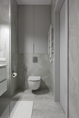 Fototapeta na wymiar modern bathroom interior with toilet, bathroom with gray tiles with stone texture
