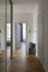 corridor in a modern apartment with light walls, coat rack in the apartment