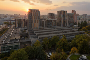 Naklejka na ściany i meble sunset over the city, view of the city with dense buildings, urban development 