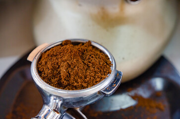 Barista is creating black coffee at the coffee machine.