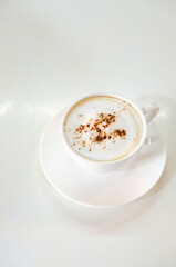 cappuccino coffee on white table soft focus