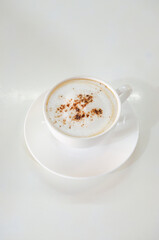 cappuccino coffee on white table soft focus