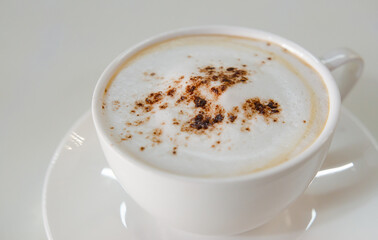 cappuccino coffee on white table soft focus