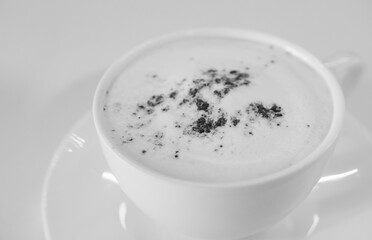 cappuccino coffee on white table soft focus