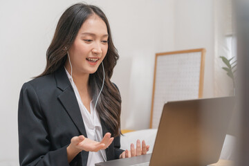Online communication, attractive asian young woman in formal suit, using laptop computer having online virtual job interview meeting conversation on video call, distance remote recruitment conference. - obrazy, fototapety, plakaty