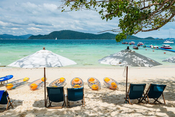 Beach chairs and canoe boats on white sand. Hey island, Phuket - obrazy, fototapety, plakaty