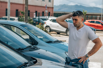 man buying car looking at stock