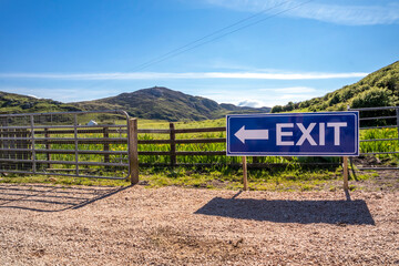 Fototapeta na wymiar Exit sign on wooden fence of a farm and camping site