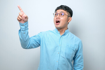 Fototapeta premium Asian young man in casual shirt pointing forward, Looking at Camera, make choosing you gesture