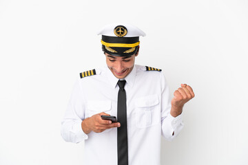Airplane pilot over isolated white background surprised and sending a message