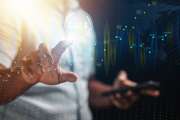 Businessman showing gold stock market bar chart growth target 2023 year of business wealth concept.