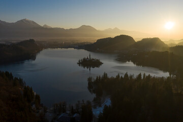 Bled Lake and Marijinega Vnebovzetja Church at Sunrise. Golden Hour. Hills and Forest. Julian Alps....