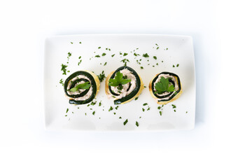 Grilled zucchini rolls with tuna and cream cheese isolated on white background	
