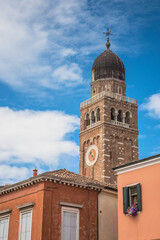Fototapeta premium Chiesa Saint Andrea catholic church building with brick bell tower, Chioggia, Italy.
