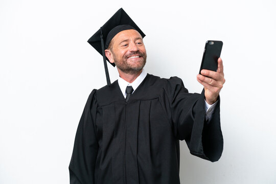 Middle age university graduate man isolated on white background making a selfie