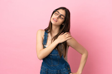 Young caucasian woman isolated on pink background suffering from pain in shoulder for having made an effort