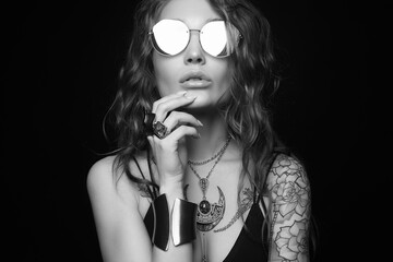 Beautiful sexy woman with tattoo. beauty tattooed girl in sunglasses and jewelry