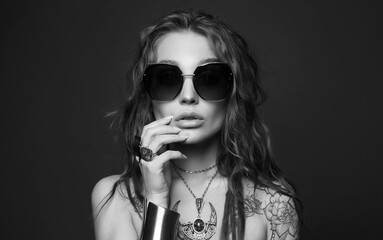 portrait of Beautiful sexy woman with tattoo. beauty tattooed girl in sunglasses