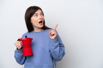 Young Russian woman holding coffee pot isolated on white background intending to realizes the solution while lifting a finger up
