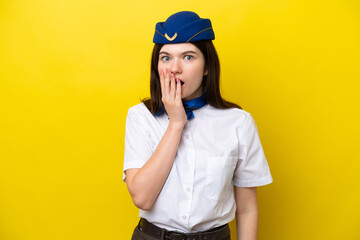 Airplane stewardess Russian woman isolated on yellow background surprised and shocked while looking right