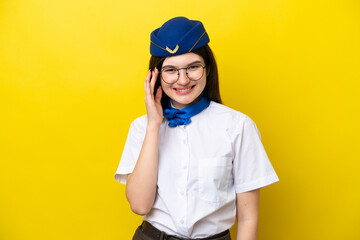 Airplane stewardess Russian woman isolated on yellow background with glasses and happy