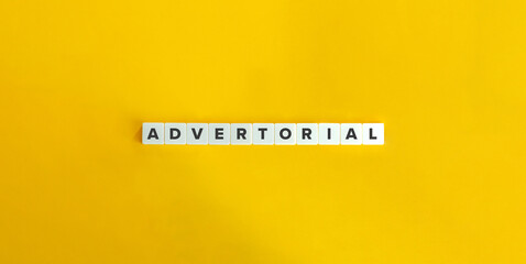 Advertorial Word on Block Letter Tiles on Yellow Background. Minimal Aesthetics.