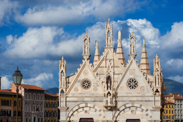 Spires and pinnacles of Santa Maria della Spina (St Mary of the Thorn) among clouds. A wonderful sample of 14th century gothic architecture in Pisa