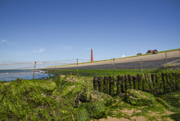 Fototapeta na wymiar Den Helder, Netherlands. July 2022. The lighthouse of Den Helder with low tide.