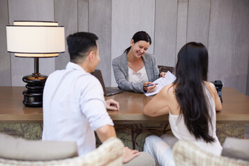 Young asian couple talking to banker or consulting agent, making legal deal, taking loan or mortgage, purchasing real estate, new apartment or house