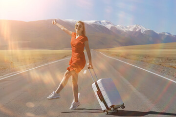 sexy girl in dress with suitcase on the highway, summer travel freedom, woman tourist
