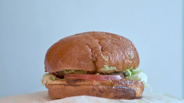 Freash beaf burger spinning on a table. 4k video footage