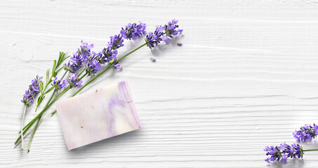 Homemade lavender soap on white wooden background.